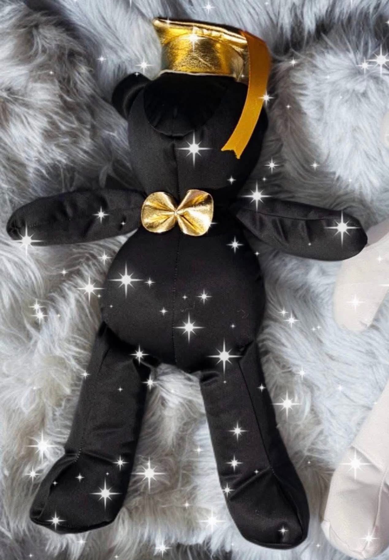 Osito de graduación negro con moño dorado